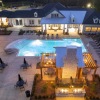 lighted clubhouse, pool and grill area at night