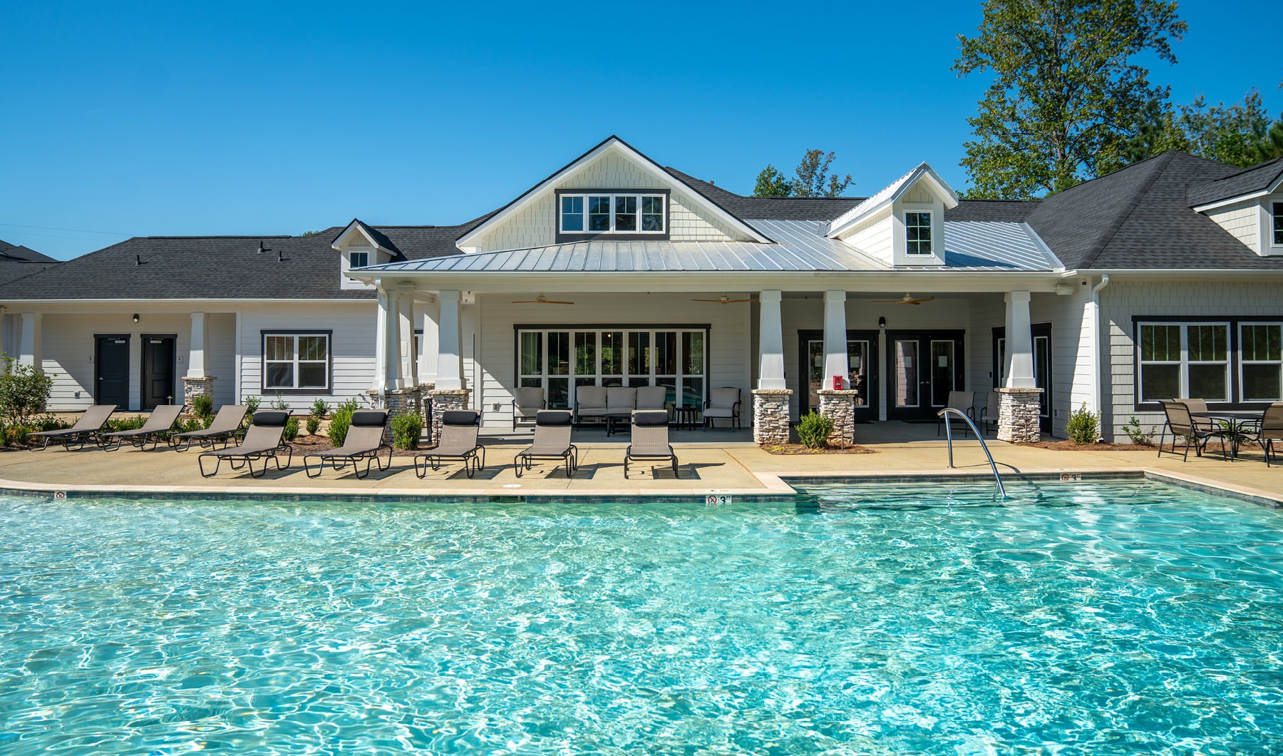 shot of outdoor swimming pool and clubhouse